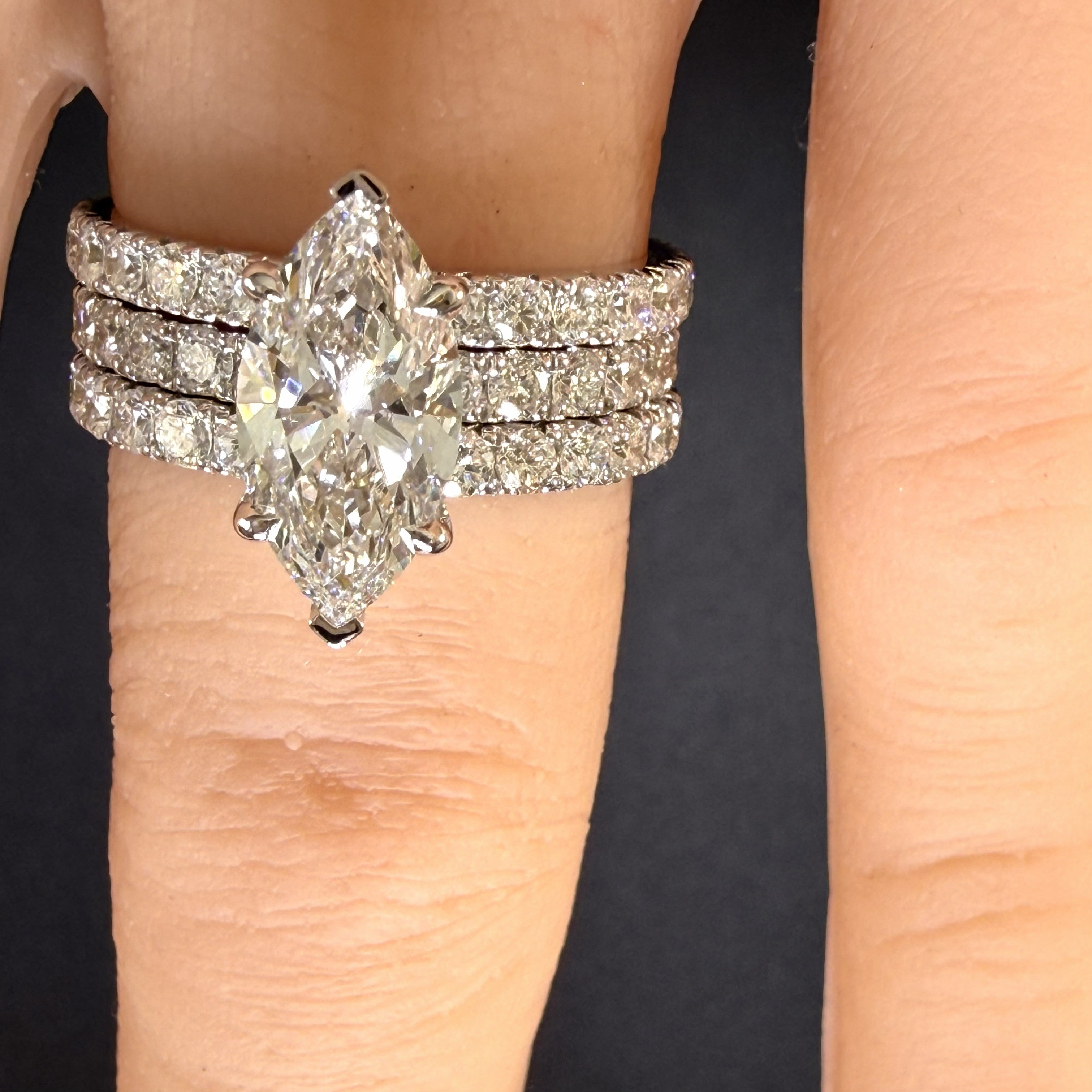 marquise-cut diamond engagement ring on finger