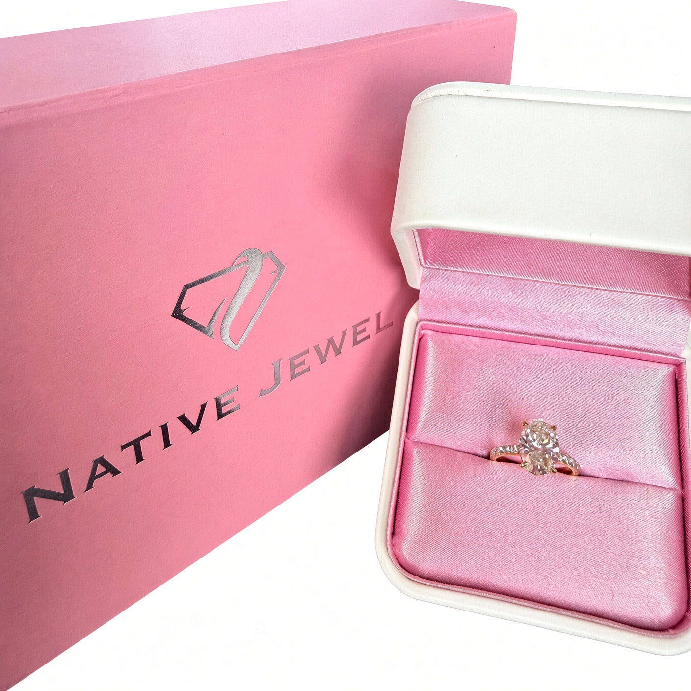 Oval diamond pavé ring in a pink ring box beside Native Jewel packaging.