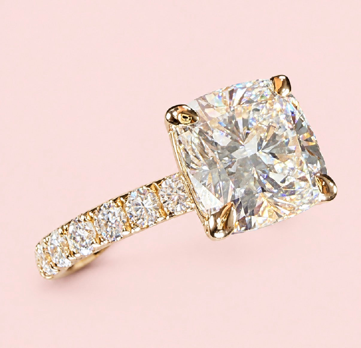 Opposite angled view of a cushion-cut diamond ring in yellow gold with diamonds along the band.