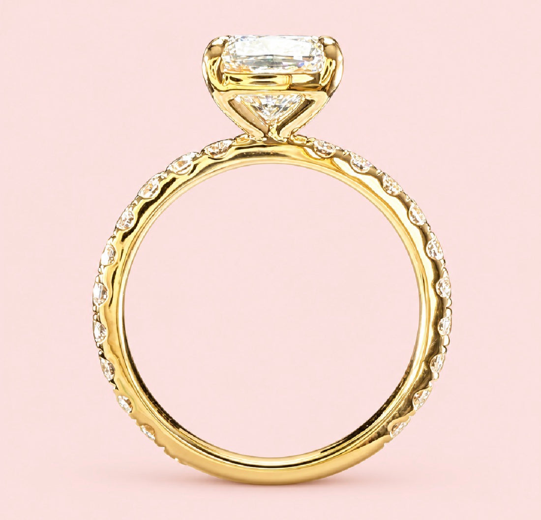 Profile view of a cushion-cut diamond ring in yellow gold showing the open gallery beneath the center diamond.