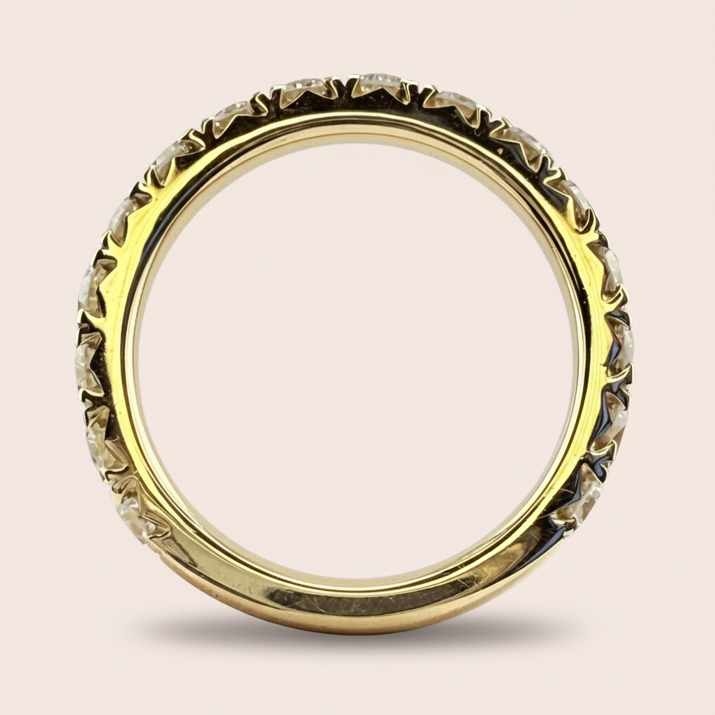 Upright side profile of a yellow-gold diamond wedding band showing the stone settings and polished inner band.