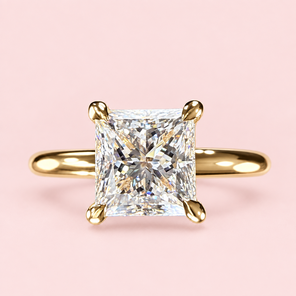 Front view of a princess-cut diamond solitaire with four yellow-gold prongs and a plain band on pink.