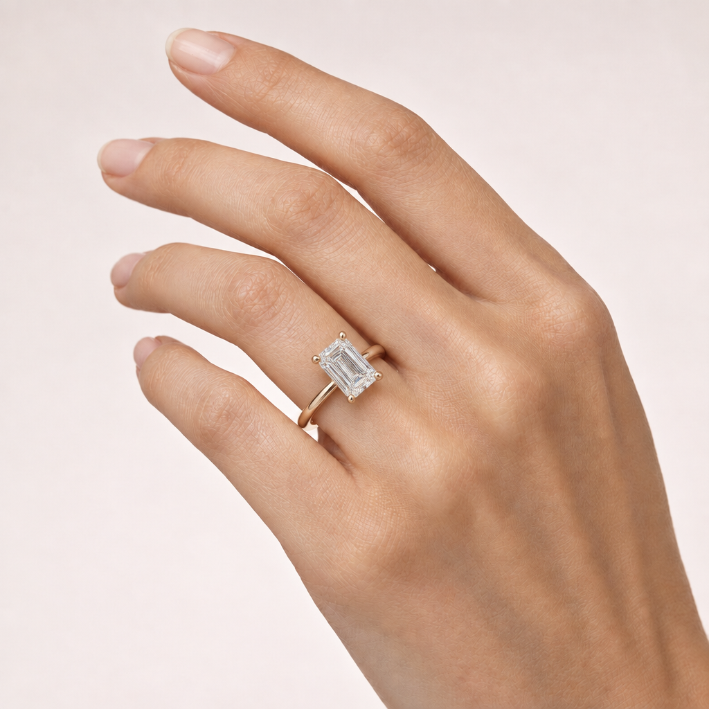 Hand wearing emerald-cut solitaire