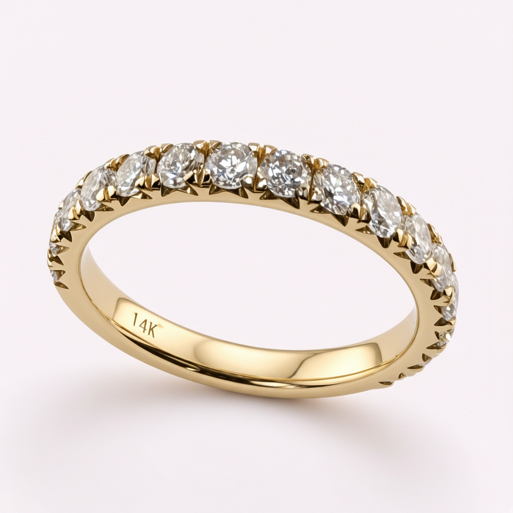 14K yellow gold 2.5mm French pavé round diamond wedding band on pale pink background