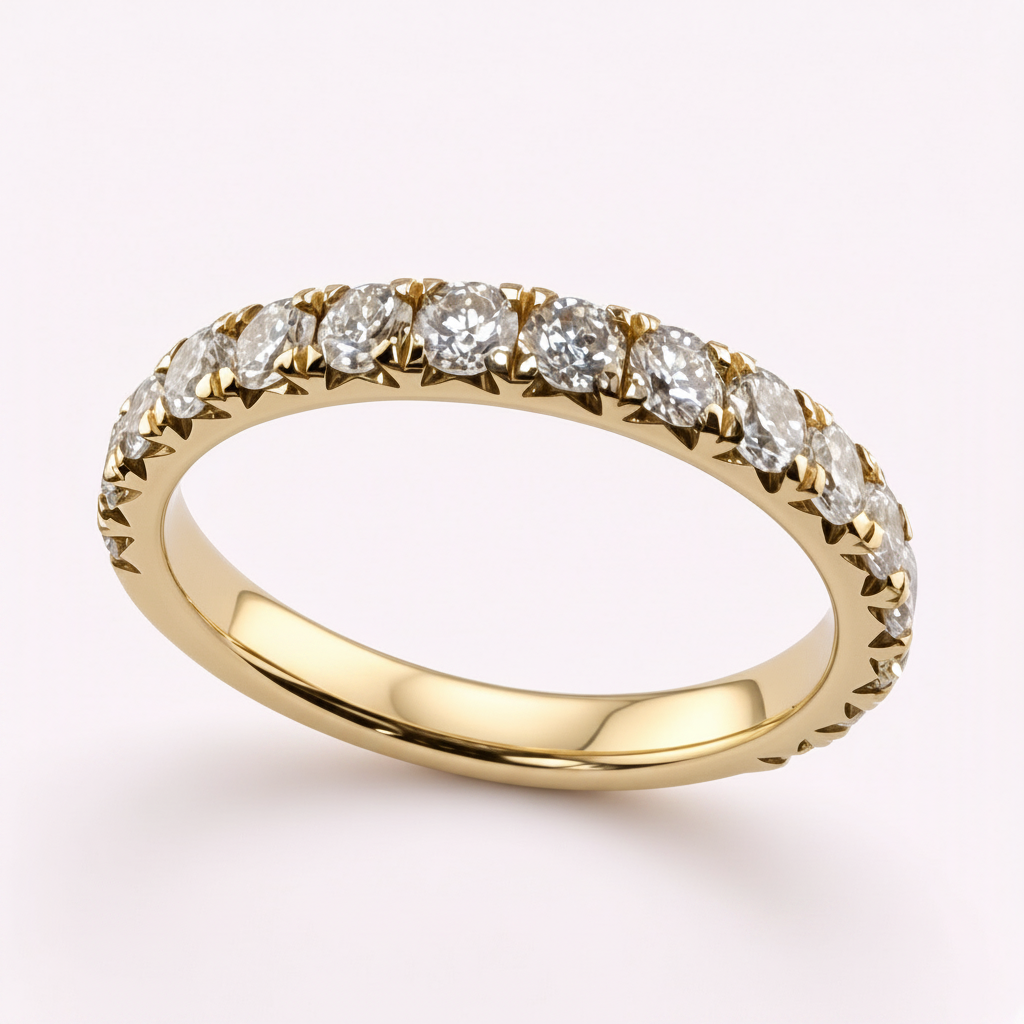 14K yellow gold 2.5mm French pavé round diamond wedding band on pale pink background