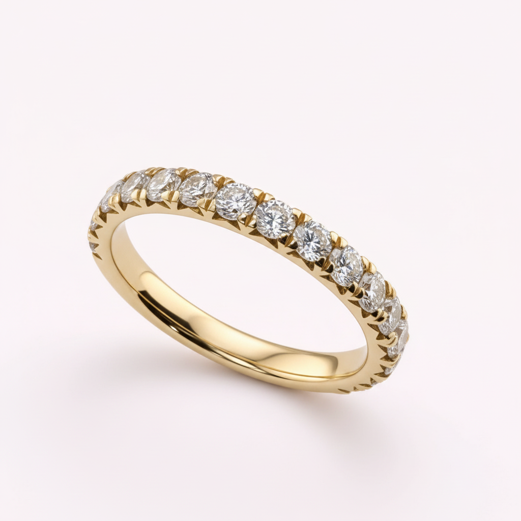 14K yellow gold 2.5mm French pavé round diamond wedding band on pale pink background