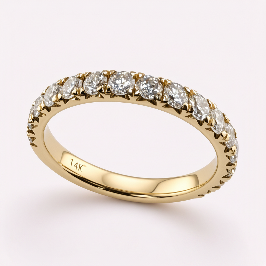 14K yellow gold 2.5mm French pavé round diamond wedding band on pale pink background