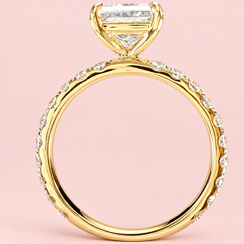 Side profile of a princess-cut diamond ring showing an open yellow-gold basket above the diamond-set band.