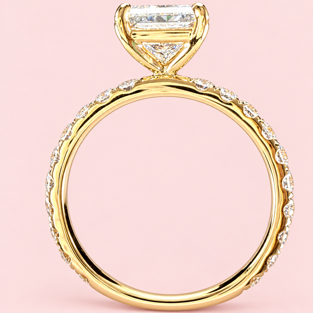 Side profile of a princess-cut diamond ring showing its open yellow-gold basket and diamond-set band.